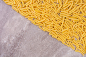 Raw uncooked pastas isolated marble surface