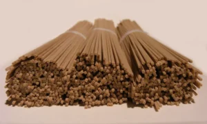 Bundled dry soba pasta noodles made from buckwheat on a white background