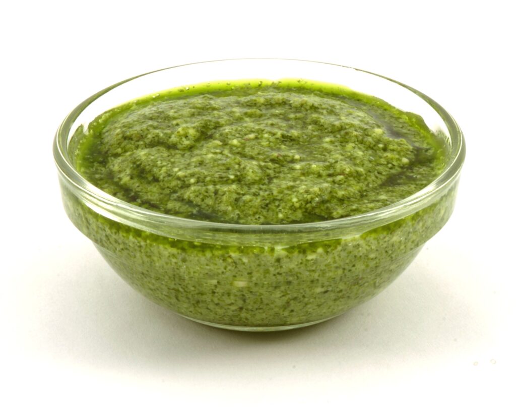 A bowl of fresh green basil pesto for traditional Pesto Genovese with Trofie.