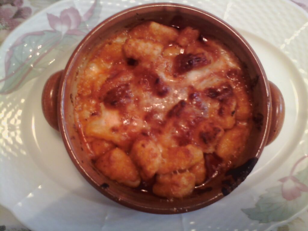 Authentic Italian Pasta alla Sorrentina baked with melted mozzarella and tomato sauce